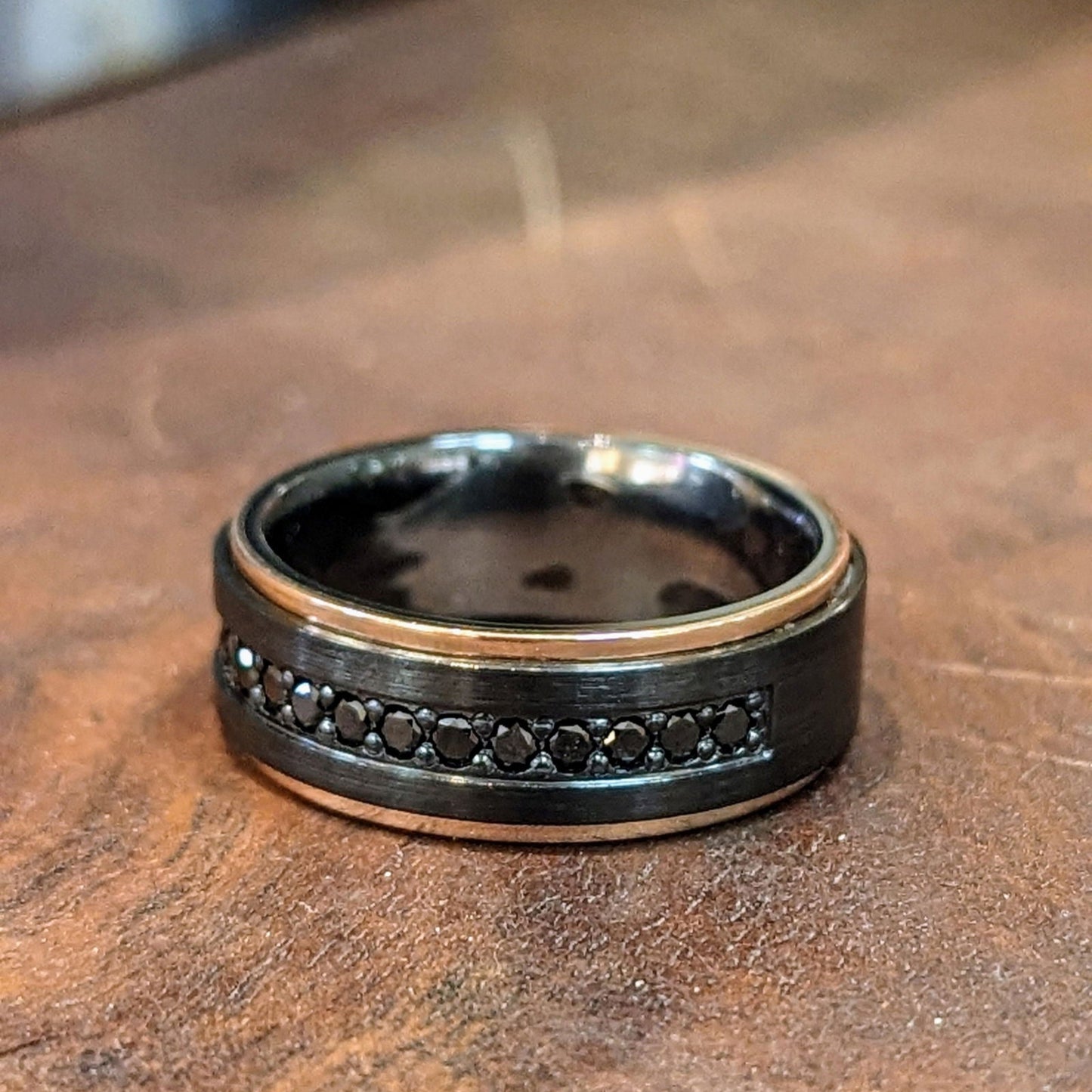 Photo of Black Diamond Zirconium Ring in a decorative scene, designed by , available at Plumb Gold & Plumb Silver
