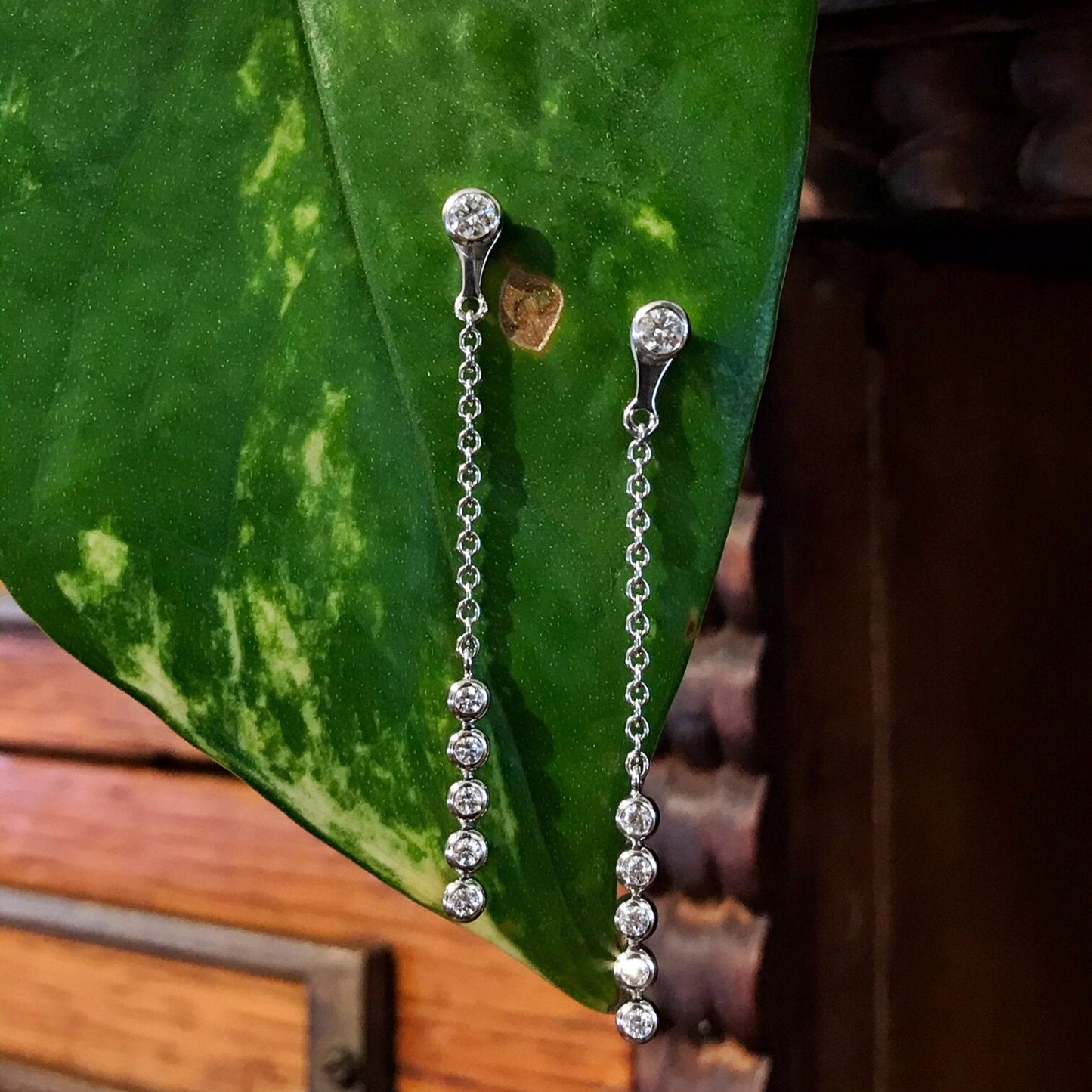 Photo of Breuning Diamond Earring Jackets in a decorative scene, designed by , available at Plumb Gold & Plumb Silver