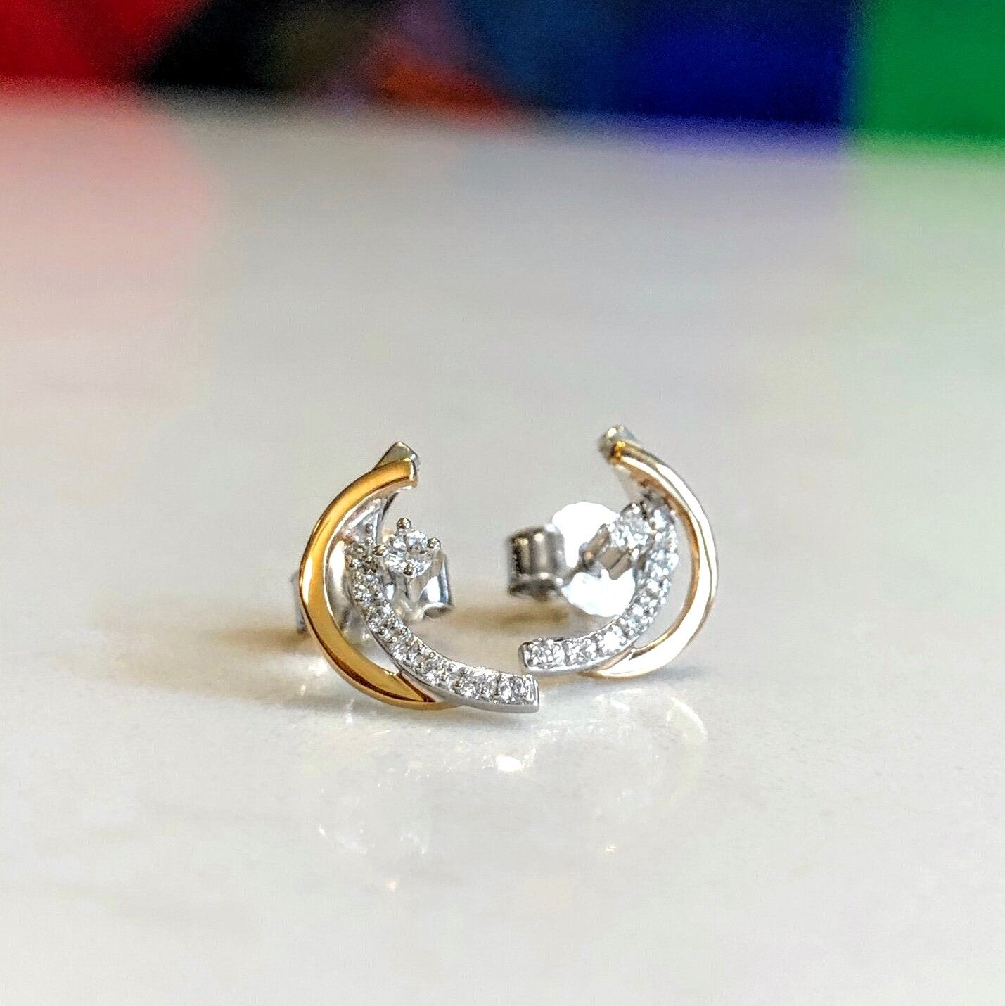 Photo of Crescent Studs in a decorative scene, designed by , available at Plumb Gold & Plumb Silver