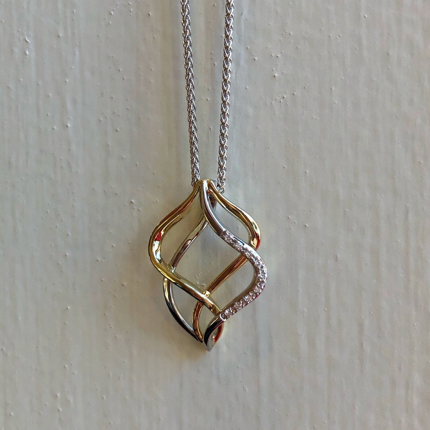 Photo of Double Open Pendant in a decorative scene, designed by , available at Plumb Gold & Plumb Silver