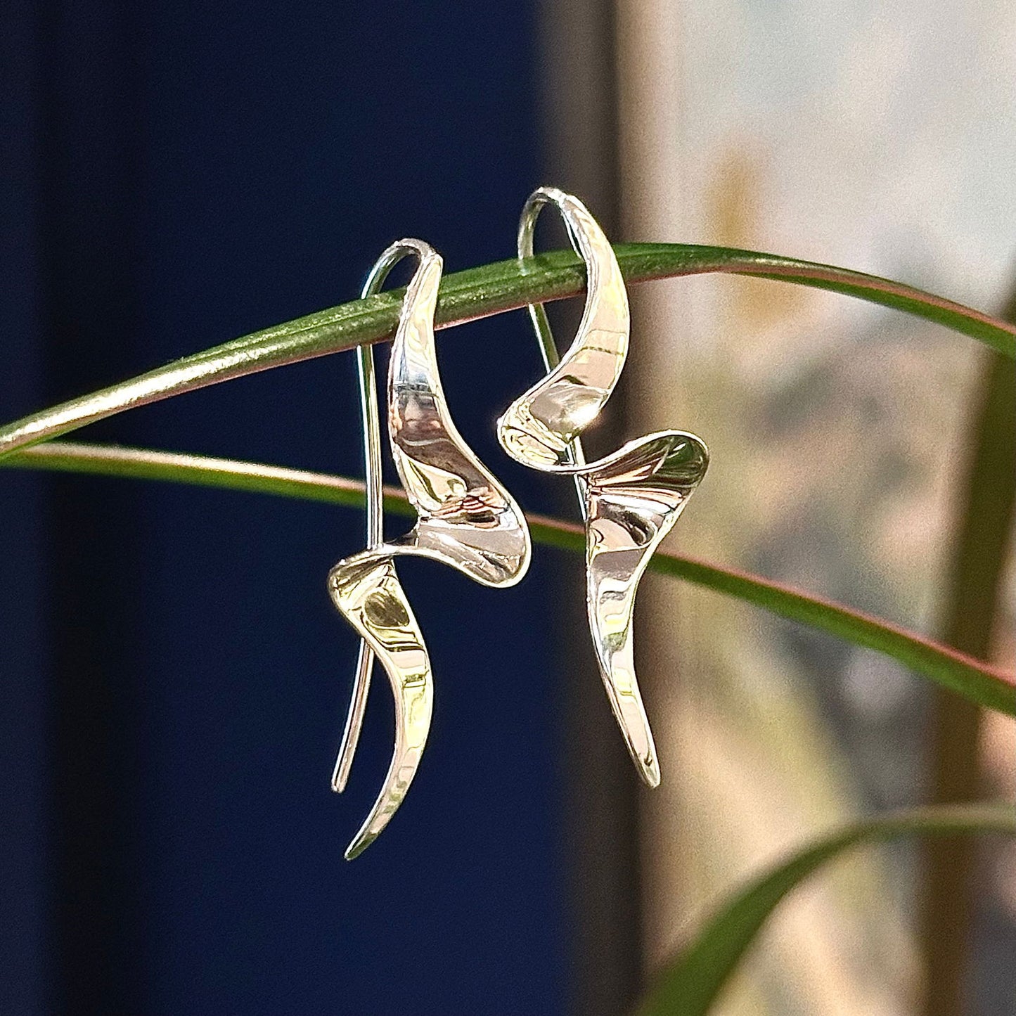 Photo of "Passage" Earrings in a decorative scene, designed by , available at Plumb Gold & Plumb Silver