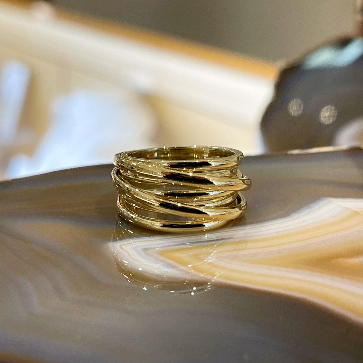 Photo of Wide Wrap Ring in a decorative scene, designed by , available at Plumb Gold & Plumb Silver