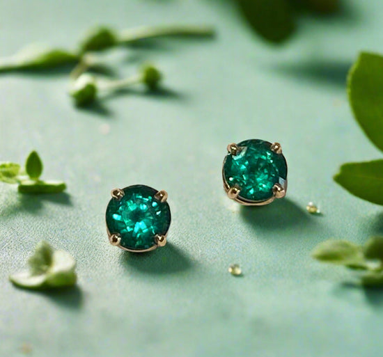 Photo of 14KY Emerald Stud Earrings 1.31Ct in a decorative scene, designed by , available at Plumb Gold & Plumb Silver