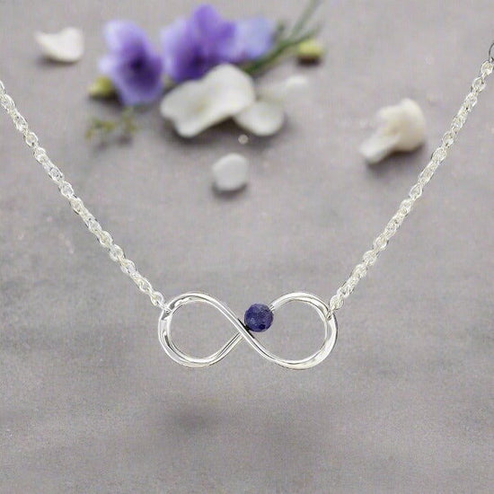 Photo of "Always" Necklace in a decorative scene, designed by , available at Plumb Gold & Plumb Silver