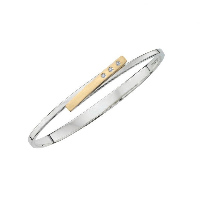 Photo of "Anticipation" Bangle in a decorative scene, designed by , available at Plumb Gold & Plumb Silver