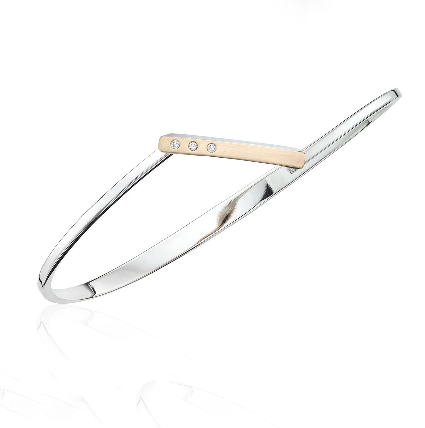 Photo of "Anticipation" Bangle in a decorative scene, designed by , available at Plumb Gold & Plumb Silver