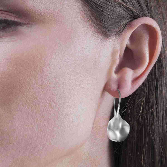 Photo of "Aqua" Earrings in a decorative scene, designed by -, available at Plumb Gold & Plumb Silver
