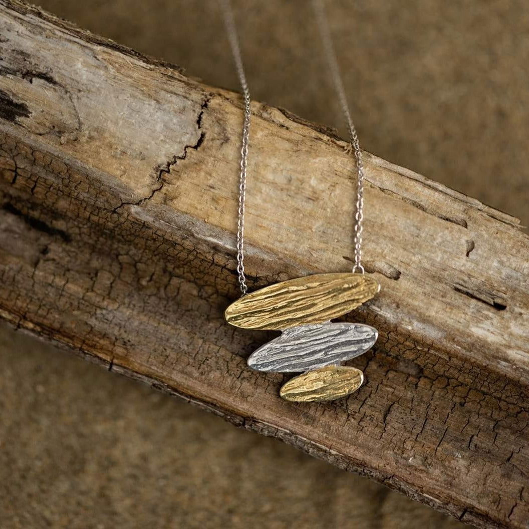 Photo of "Arizona" Necklace in a decorative scene, designed by , available at Plumb Gold & Plumb Silver