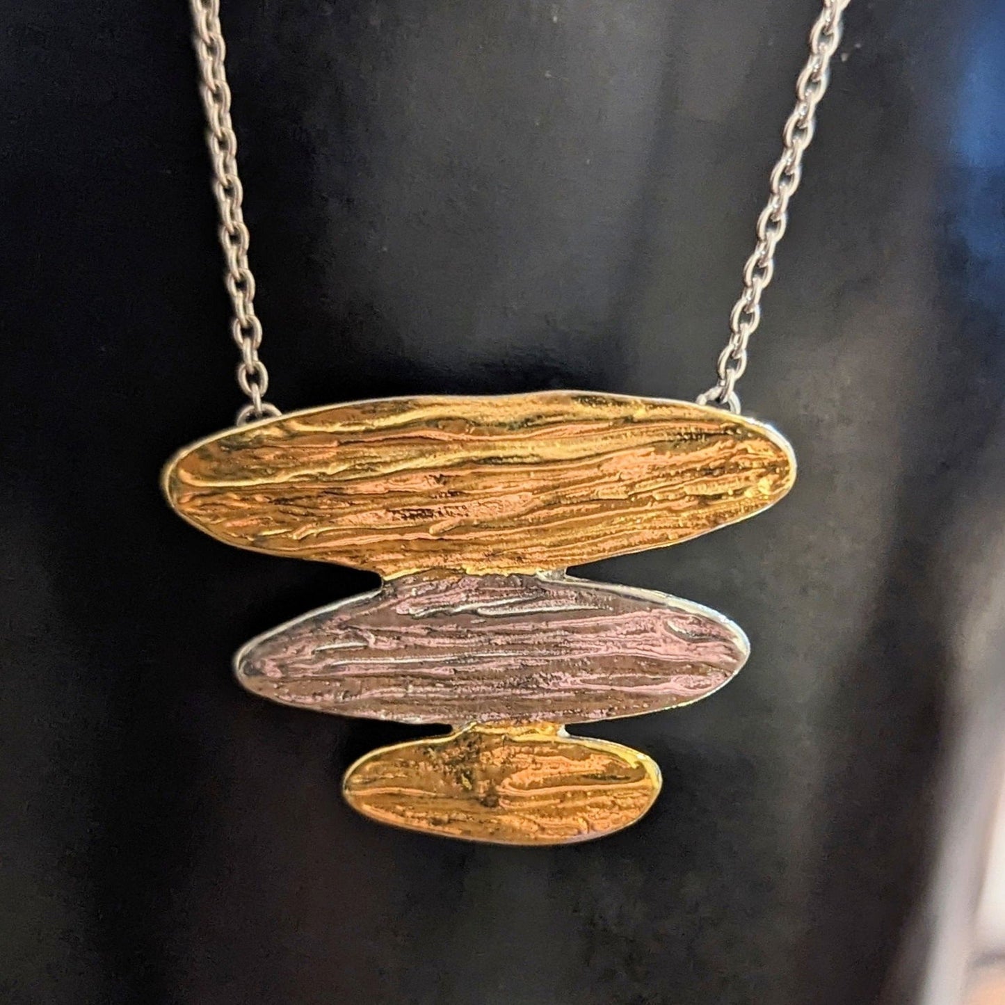 Photo of "Arizona" Necklace in a decorative scene, designed by , available at Plumb Gold & Plumb Silver