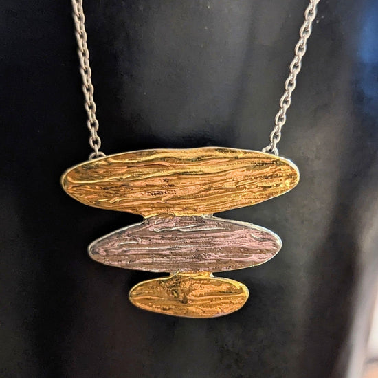 Photo of "Arizona" Necklace in a decorative scene, designed by , available at Plumb Gold & Plumb Silver