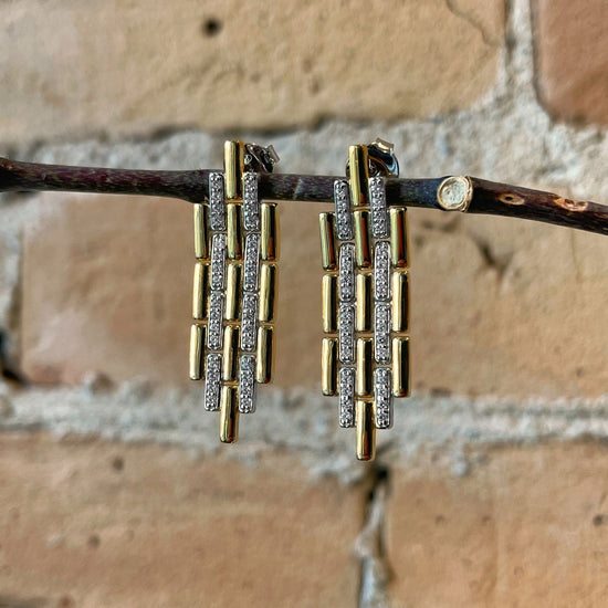 Photo of Art Deco Link Earrings in a decorative scene, designed by , available at Plumb Gold & Plumb Silver