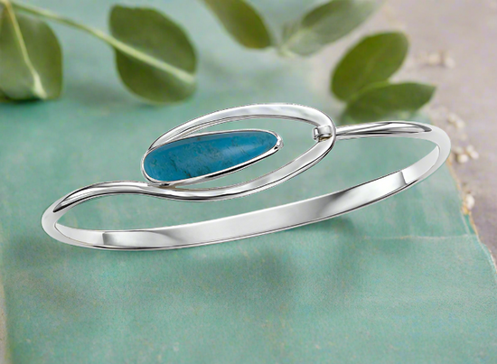 Photo of "Aurora" Turquoise Bracelet in a decorative scene, designed by , available at Plumb Gold & Plumb Silver