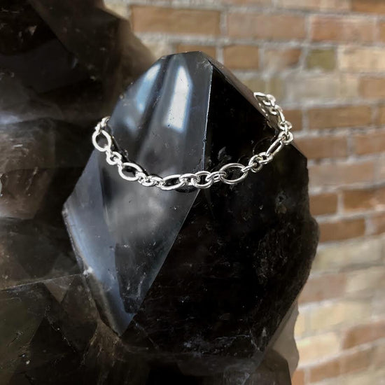Photo of Baroque Figaro Bracelet in a decorative scene, designed by , available at Plumb Gold & Plumb Silver