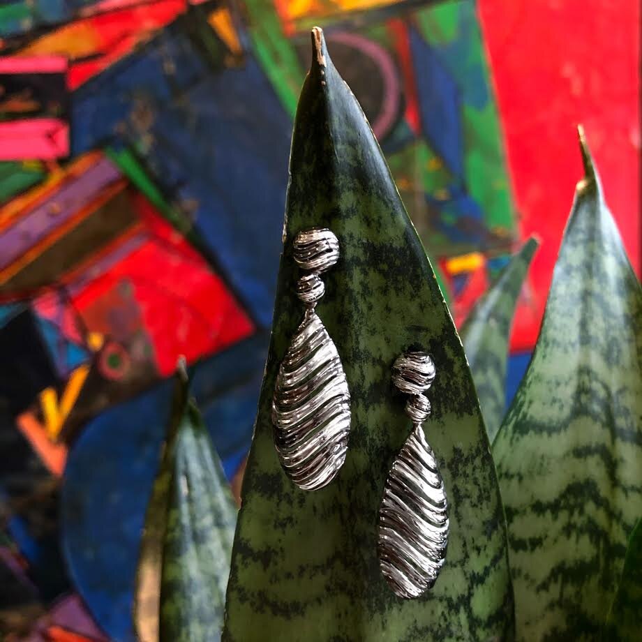 Photo of "Bay" Dangle Earring in a decorative scene, designed by , available at Plumb Gold & Plumb Silver