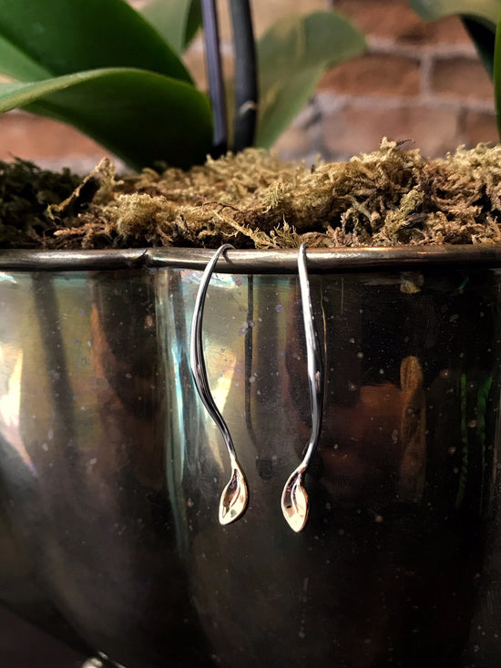 Photo of "Be-Leaf" Earrings in a decorative scene, designed by , available at Plumb Gold & Plumb Silver