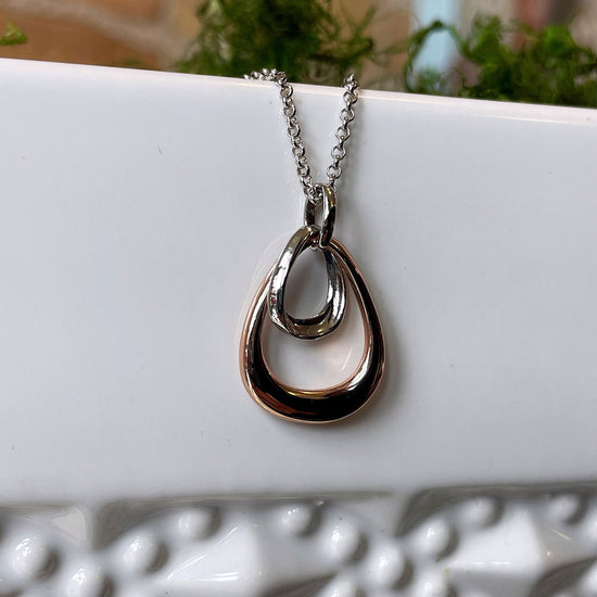 Photo of “Bell” Pendant in a decorative scene, designed by , available at Plumb Gold & Plumb Silver