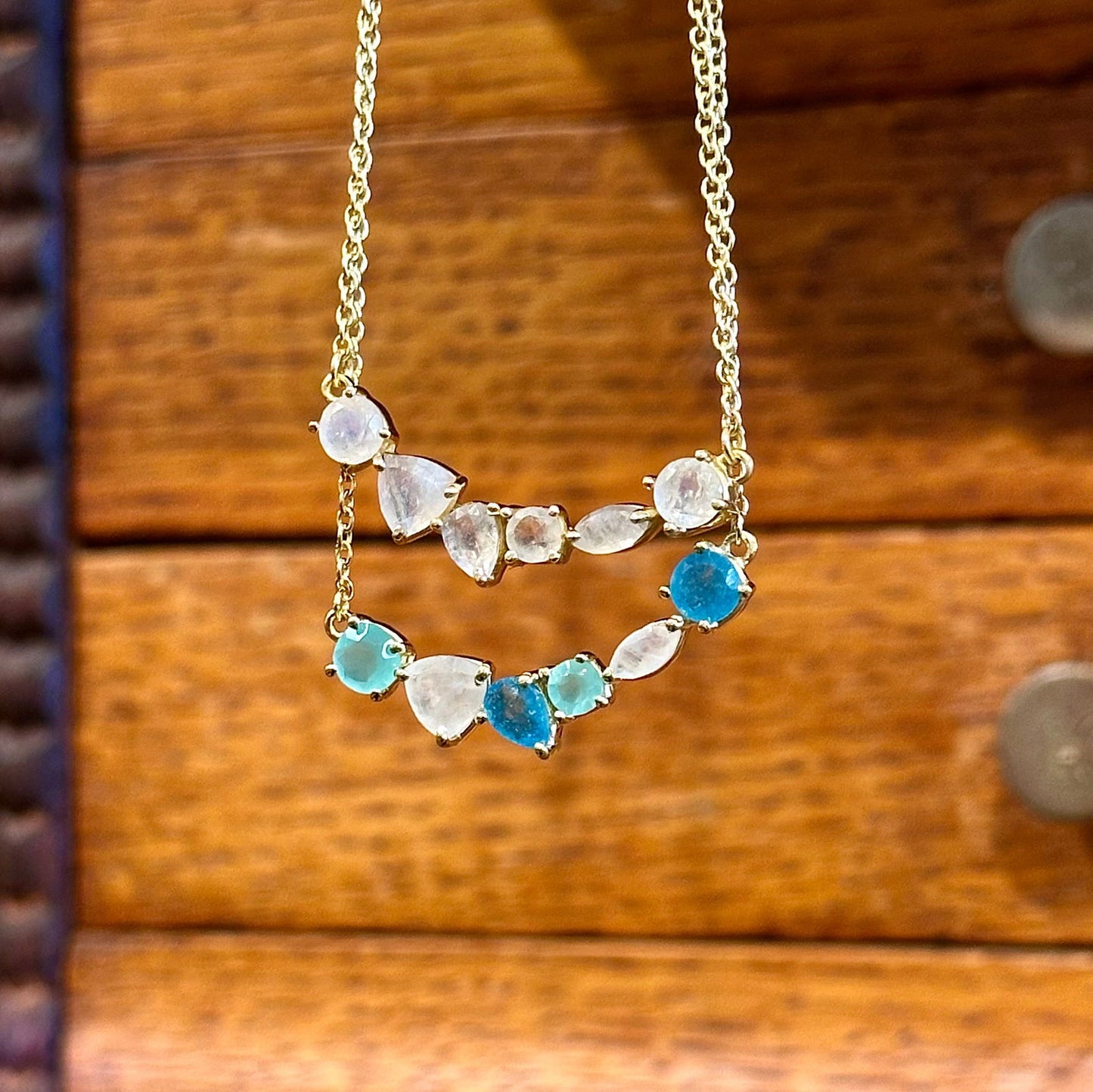 Photo of “Bella” Necklace in a decorative scene, designed by -, available at Plumb Gold & Plumb Silver