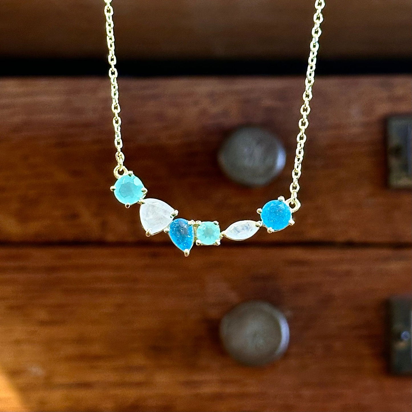 Photo of “Bella” Necklace in a decorative scene, designed by -, available at Plumb Gold & Plumb Silver