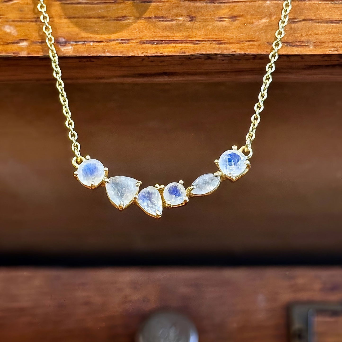 Photo of “Bella” Necklace in a decorative scene, designed by -, available at Plumb Gold & Plumb Silver