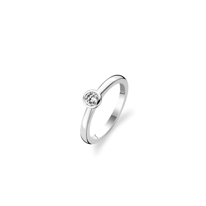 Photo of Bezel CZ Solitaire in a decorative scene, designed by , available at Plumb Gold & Plumb Silver