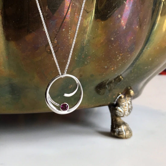 Photo of "Bindu" Necklace in a decorative scene, designed by , available at Plumb Gold & Plumb Silver