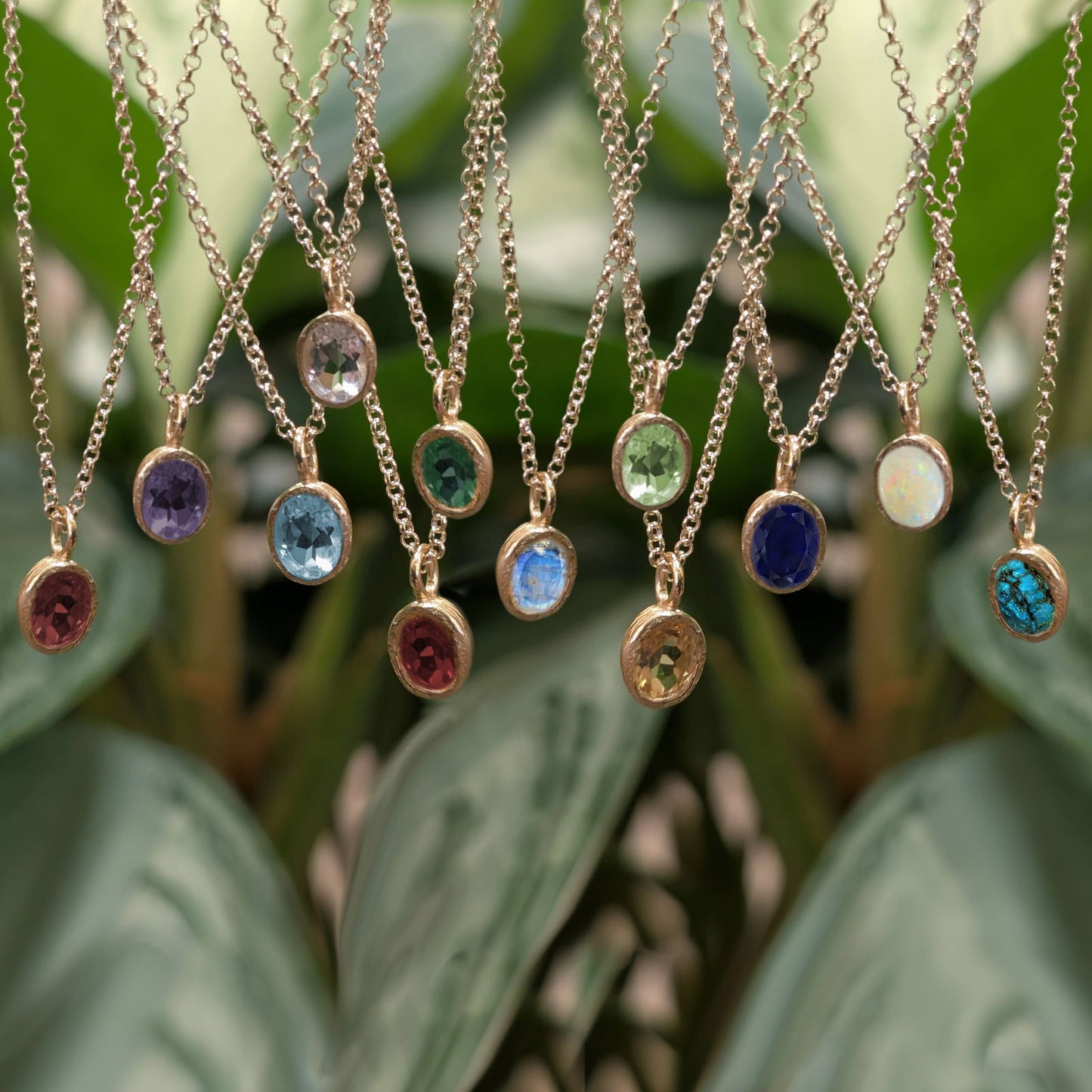 Photo of Birthstone Pendants By Jorge in a decorative scene, designed by -, available at Plumb Gold & Plumb Silver