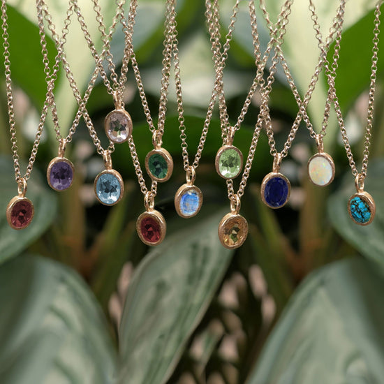 Photo of Birthstone Pendants By Jorge in a decorative scene, designed by -, available at Plumb Gold & Plumb Silver