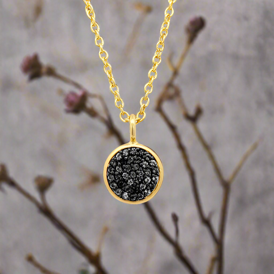 Photo of Black Spinel Pavé Necklace in a decorative scene, designed by -, available at Plumb Gold & Plumb Silver