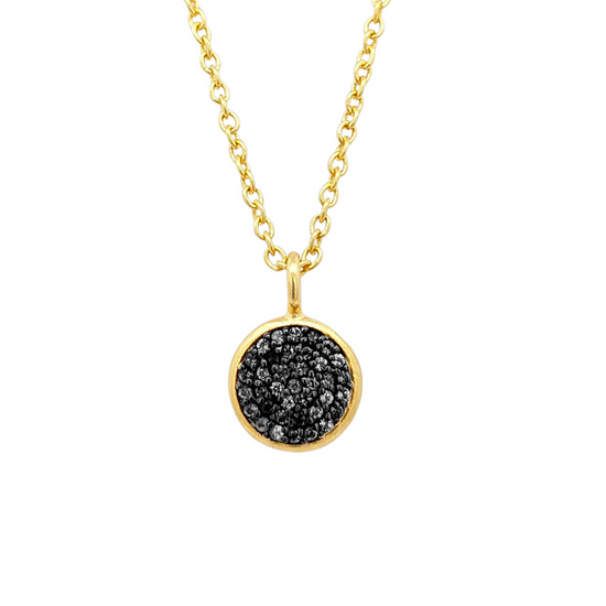 Photo of Black Spinel Pavé Necklace in a decorative scene, designed by -, available at Plumb Gold & Plumb Silver