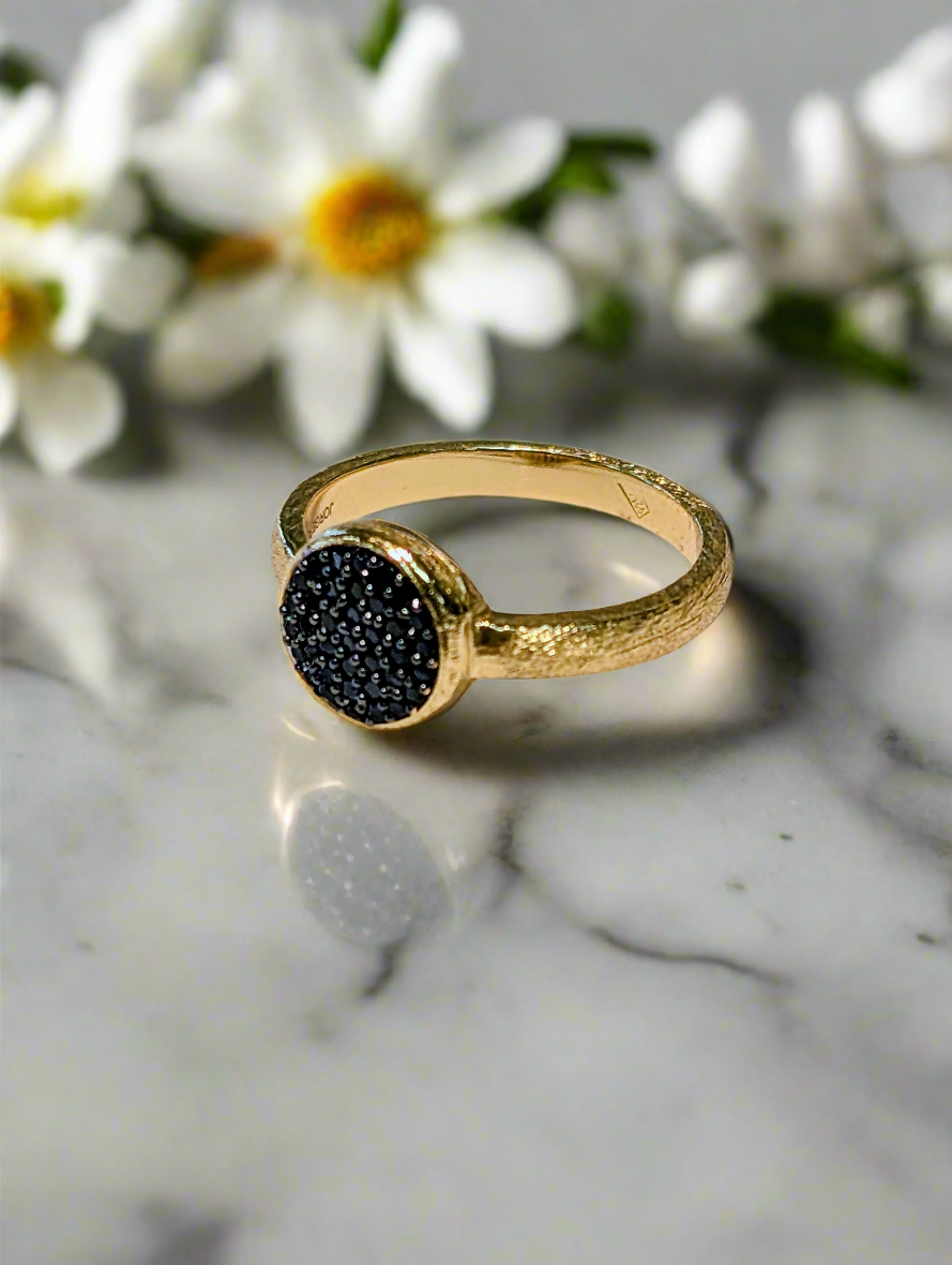 Photo of Black Spinel Pavé Ring in a decorative scene, designed by -, available at Plumb Gold & Plumb Silver