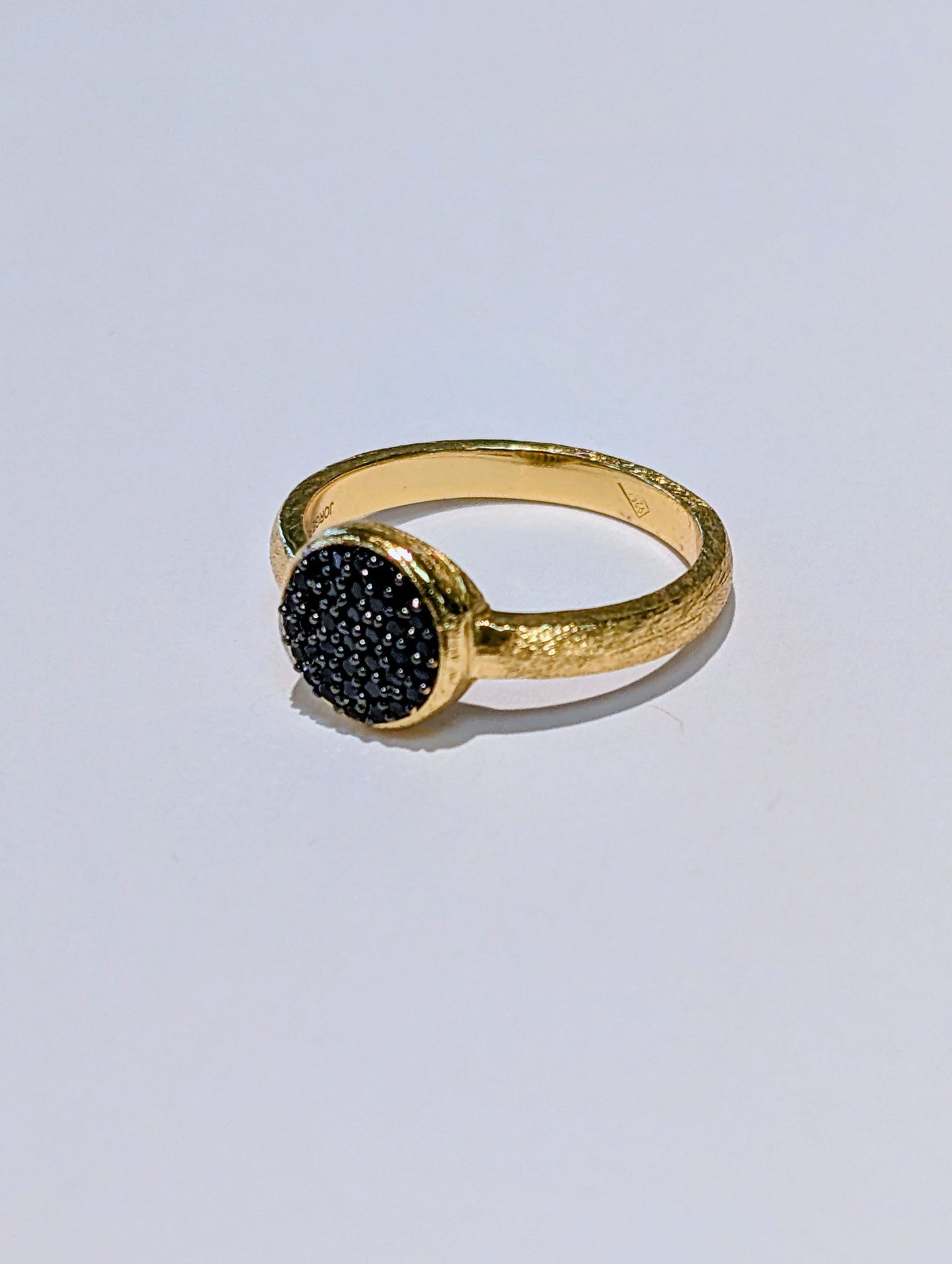 Photo of Black Spinel Pavé Ring in a decorative scene, designed by -, available at Plumb Gold & Plumb Silver