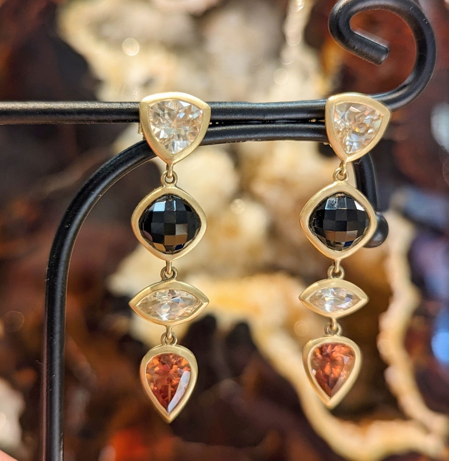 Photo of Black spinel and Zircon dangles in a decorative scene, designed by , available at Plumb Gold & Plumb Silver