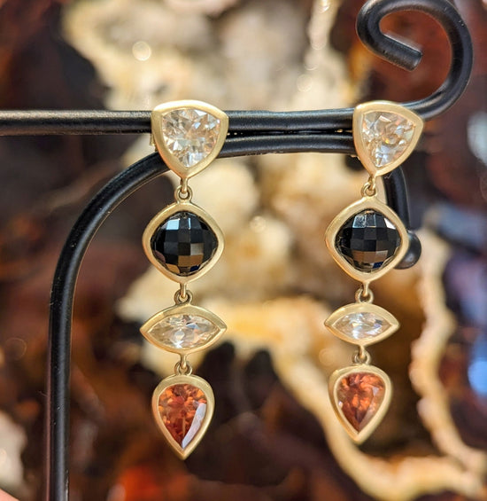 Photo of Black spinel and Zircon dangles in a decorative scene, designed by , available at Plumb Gold & Plumb Silver