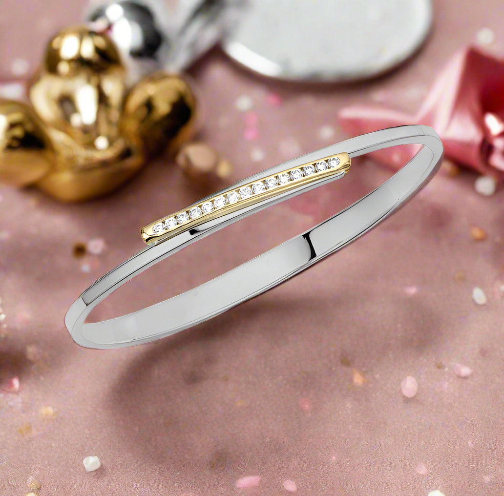 Photo of "Bling Swing" Bangle in a decorative scene, designed by , available at Plumb Gold & Plumb Silver