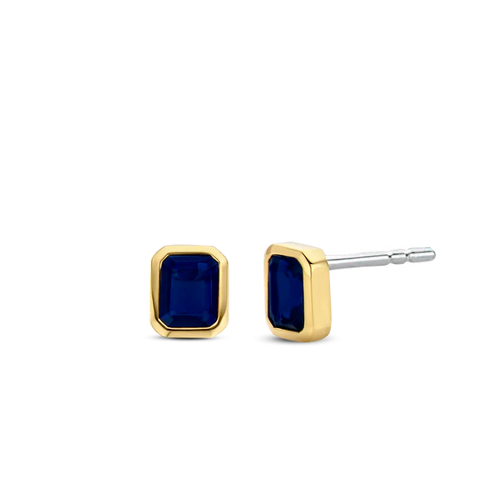Photo of Blue Cubic Zirconia Studs in a decorative scene, designed by , available at Plumb Gold & Plumb Silver