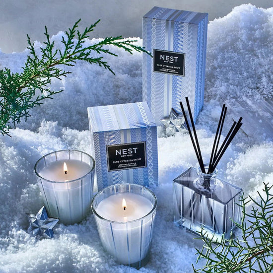 Photo of Blue Cypress & Snow Candle in a decorative scene, designed by , available at Plumb Gold & Plumb Silver