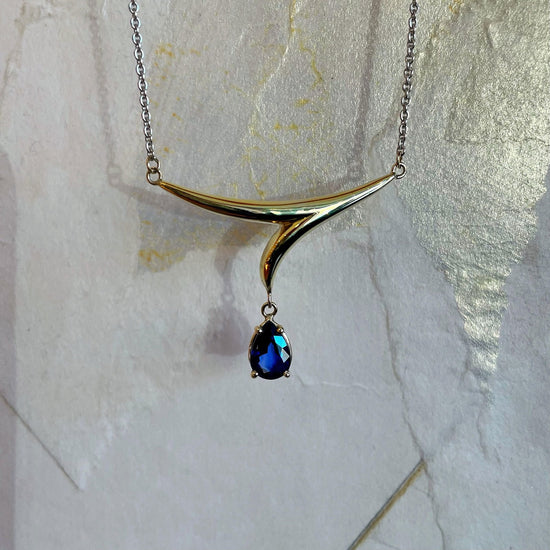 Photo of Blue Sapphire Necklace in a decorative scene, designed by , available at Plumb Gold & Plumb Silver