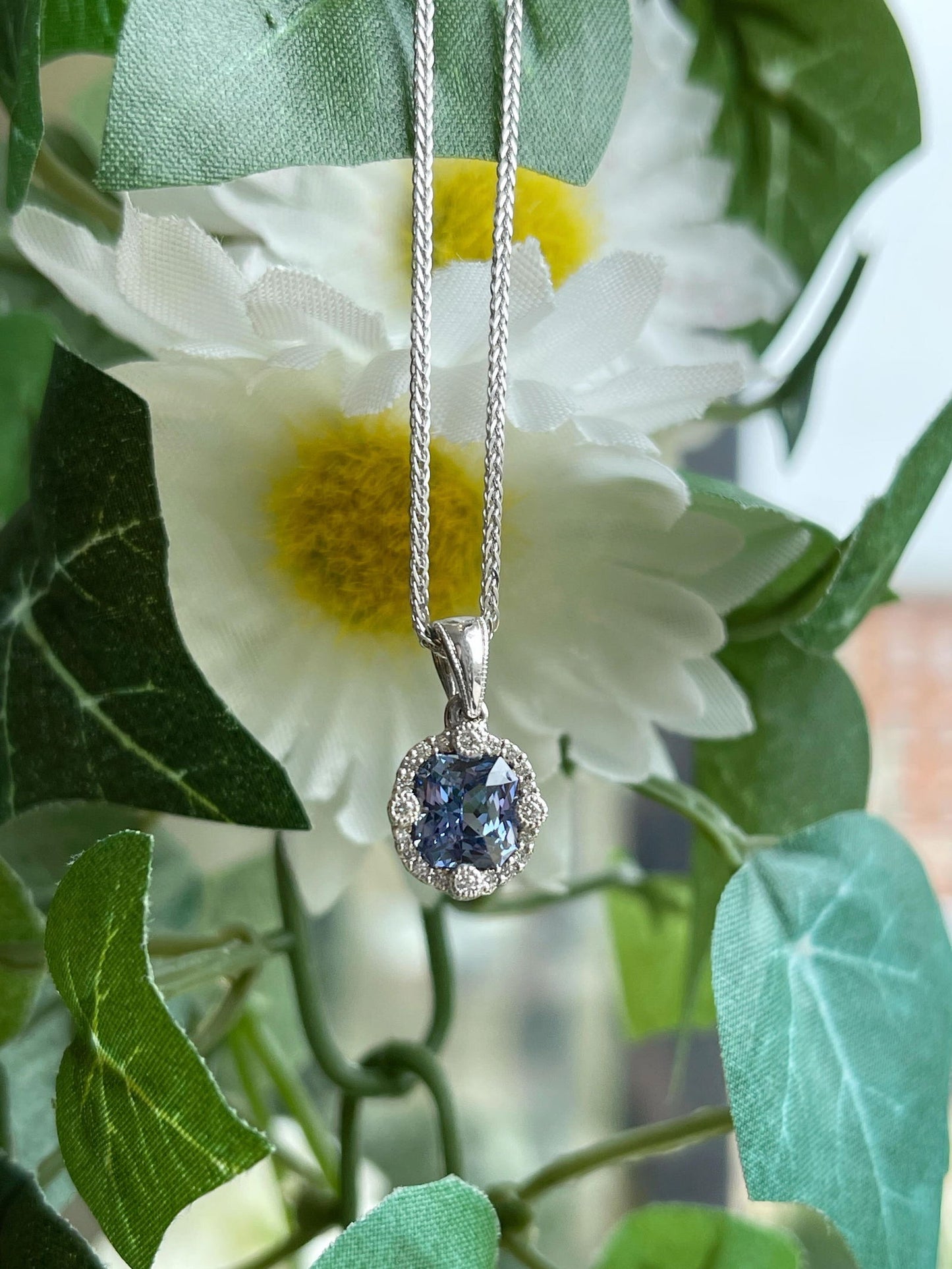 Photo of Blue Sapphire Pendant in a decorative scene, designed by , available at Plumb Gold & Plumb Silver