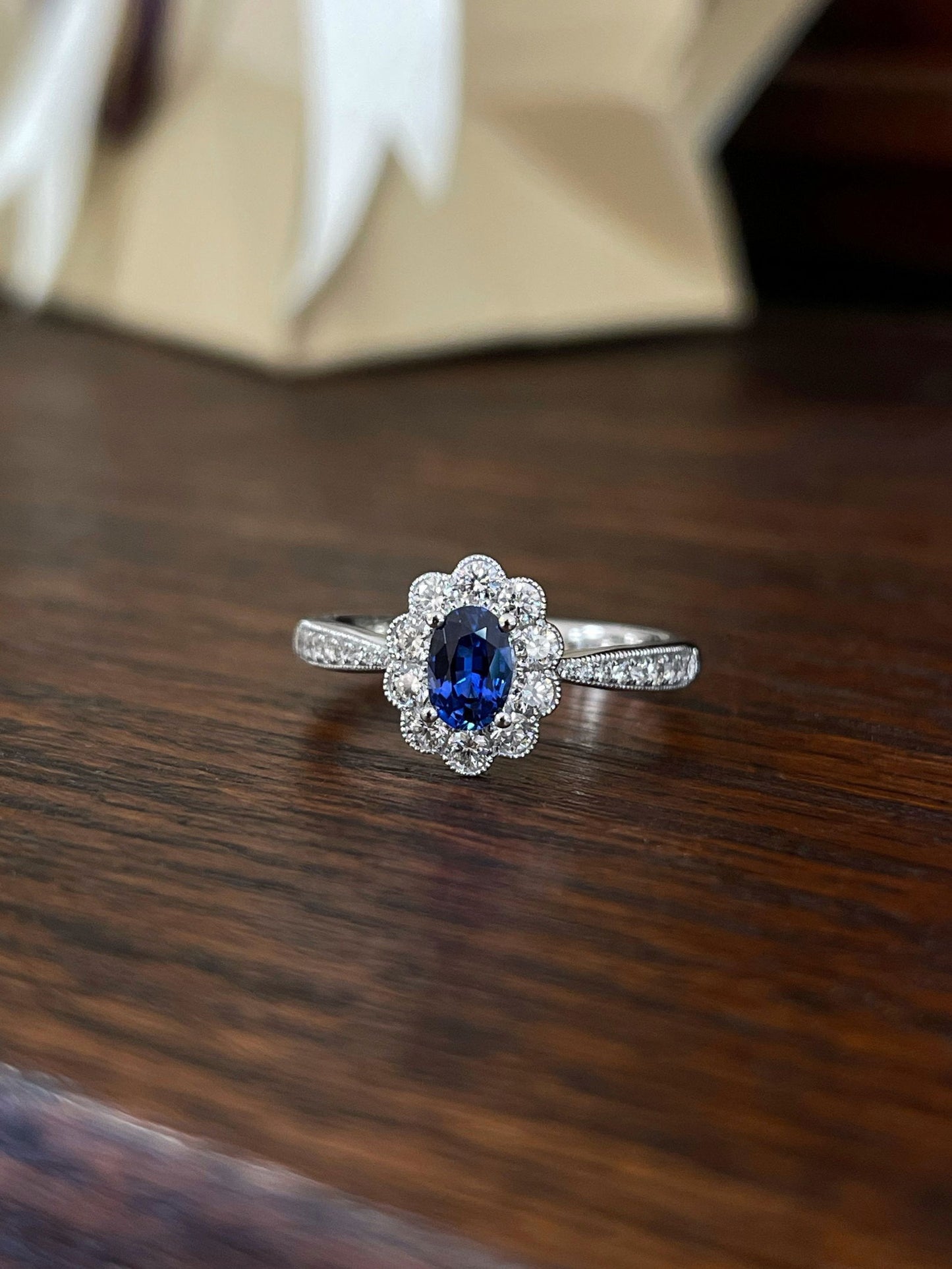 Photo of Blue Sapphire and Diamond Ring in a decorative scene, designed by , available at Plumb Gold & Plumb Silver