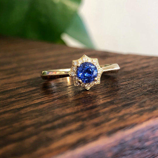 Photo of Blue Sapphire and Diamond Web Ring in a decorative scene, designed by , available at Plumb Gold & Plumb Silver