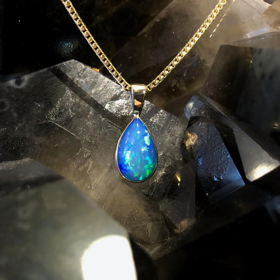 Photo of Blue Teardrop Ethiopian Opal in a decorative scene, designed by , available at Plumb Gold & Plumb Silver