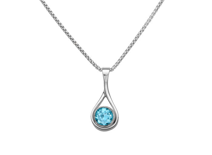 Photo of Blue Topaz "Desire" Pendant in a decorative scene, designed by , available at Plumb Gold & Plumb Silver