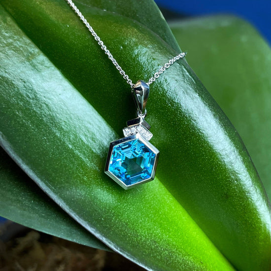 Photo of Blue Topaz Diamond Necklace in a decorative scene, designed by , available at Plumb Gold & Plumb Silver