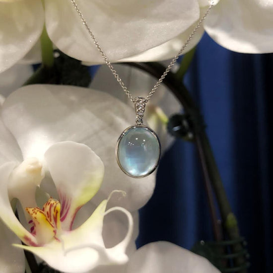 Photo of Blue Topaz Over Mother of Pearl Necklace in a decorative scene, designed by , available at Plumb Gold & Plumb Silver
