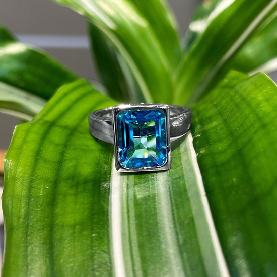 Photo of Blue Topaz Ring in a decorative scene, designed by , available at Plumb Gold & Plumb Silver