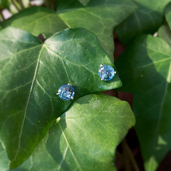 Photo of Blue Topaz Studs in a decorative scene, designed by , available at Plumb Gold & Plumb Silver