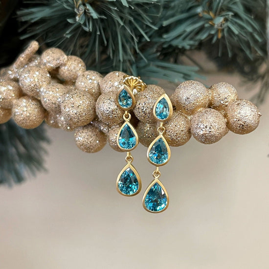 Photo of Blue Zircon Dangles in a decorative scene, designed by , available at Plumb Gold & Plumb Silver