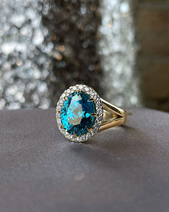 Photo of Blue Zircon Ring in a decorative scene, designed by , available at Plumb Gold & Plumb Silver