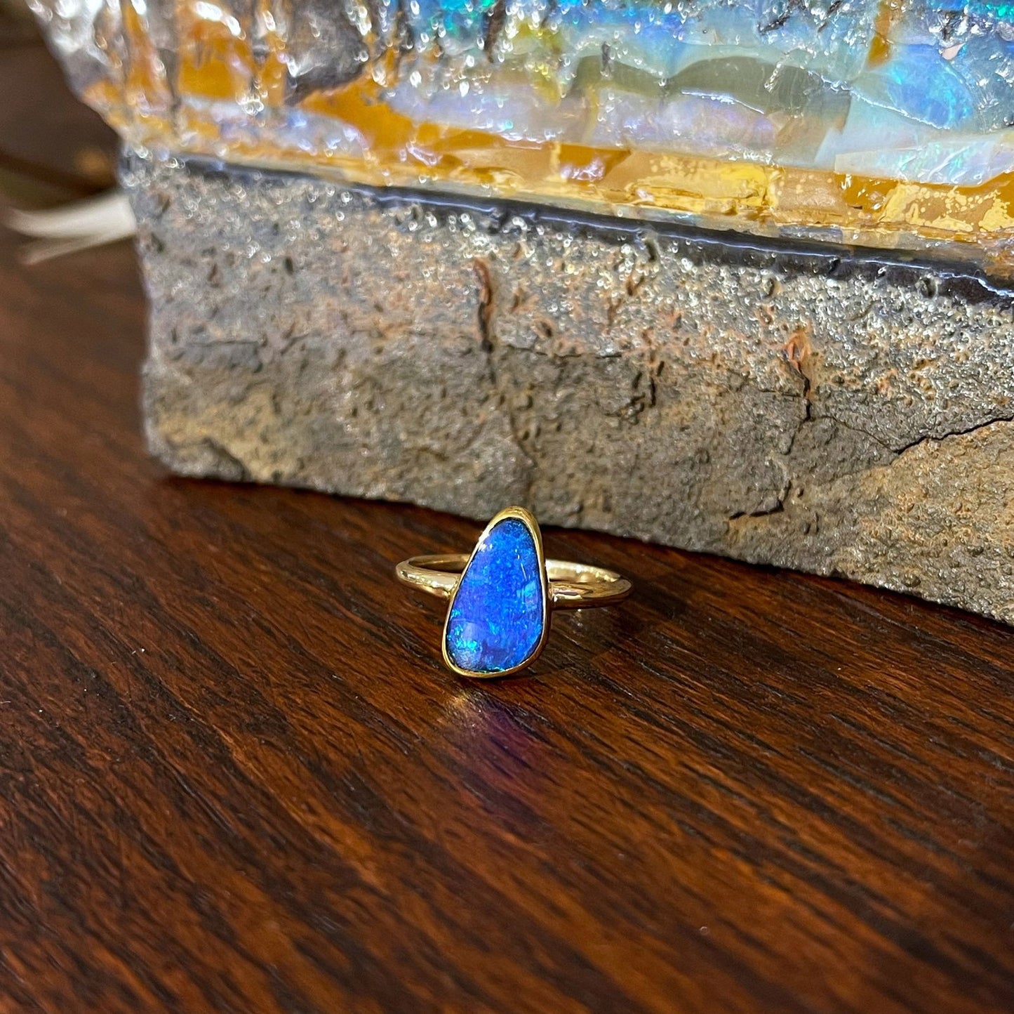 Photo of Boulder Opal Ring in a decorative scene, designed by , available at Plumb Gold & Plumb Silver