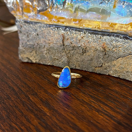 Photo of Boulder Opal Ring in a decorative scene, designed by , available at Plumb Gold & Plumb Silver